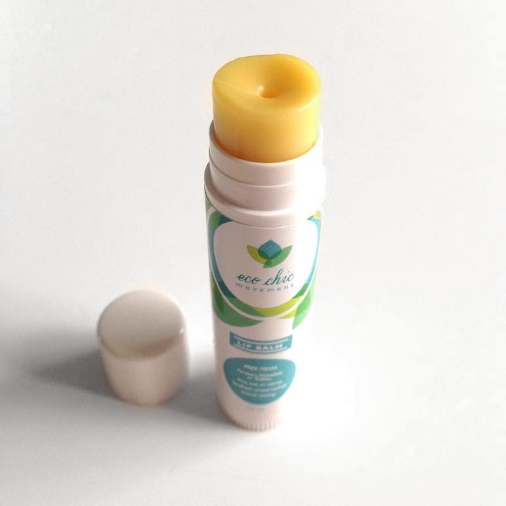 A tube of yellow Eco Chic Movement lip balm is shown on a white background, one of our non toxic skincare products
