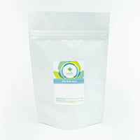 A white pouch of natural sitz bath soak for postpartum healing sits on a white table