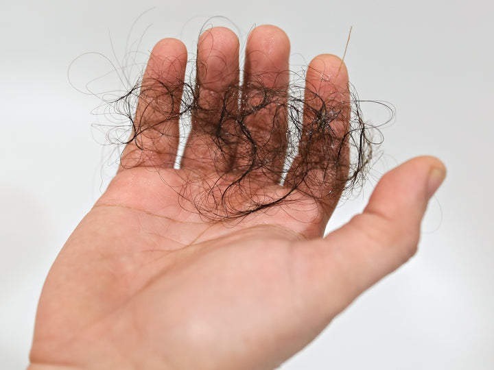 handful of hair falling out postpartum