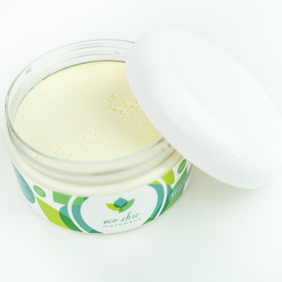 An open jar of natural belly butter for pregnancy on a white table