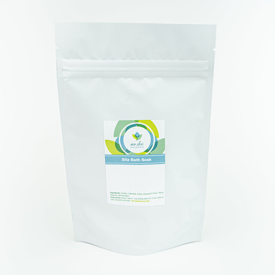 A white pouch of natural sitz bath soak for postpartum healing sits on a white table